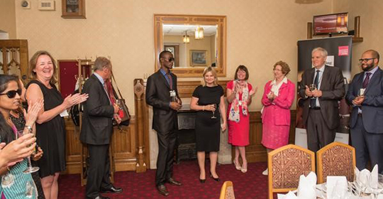 Leroy Philips (center) with Justine Greening, UK Secretary of State for International Development