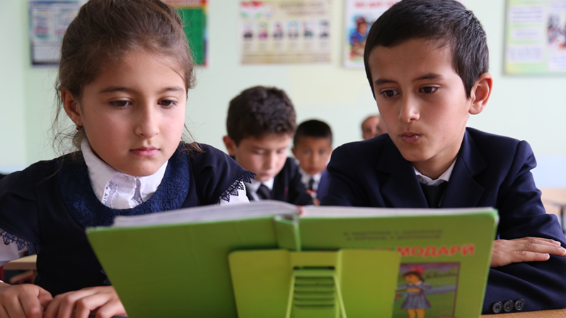 Credit/ALT text: Two students read from a book in the #39 school in Tajikistan. Credit: GPE/Carine Durand Credit/ALT text: Two students read from a book in the #39 school in Tajikistan. Credit: GPE/Carine Durand