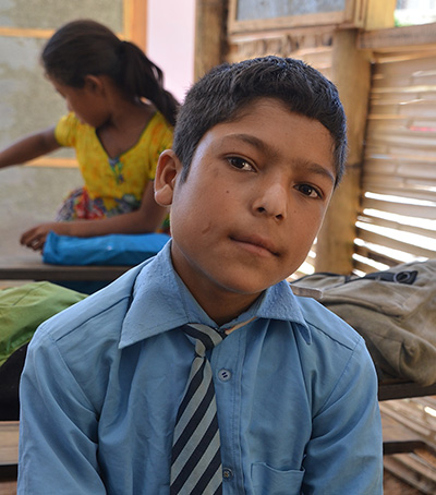 Dipesh, a student at Shree Mahendrodaya Higher Secondary School in Nepal at his desk © GPE/Aya Kibesaki